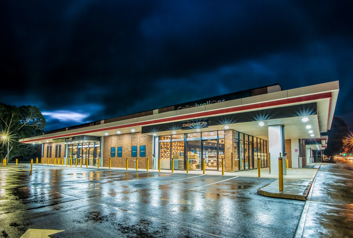 Supermarket exterior lit up at night